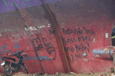 Graffiti on ship that was tossed on shore during storm surge says it all. Photo by Jude Bautista