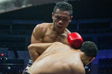 Parra clinches again after getting staggered. PINOY PRIDE 30 D-Day was held at the SMART Araneta Coliseum last March 28, 2015. Photo by Jude Bautista